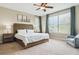 The primary bedroom features a large window, comfortable furnishings, and plenty of natural light at 10029 Winterthur Ct, Highlands Ranch, CO 80129