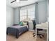 Bedroom with a bed, desk, chair, window, and light blue walls at 10029 Winterthur Ct, Highlands Ranch, CO 80129