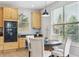 Cozy breakfast nook with bright light, a dark table, and wood cabinets at 10029 Winterthur Ct, Highlands Ranch, CO 80129