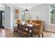 Charming dining room with natural light and hardwood floors offers a rustic table with seating and decor at 10029 Winterthur Ct, Highlands Ranch, CO 80129
