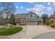 Inviting two-story home featuring a two-car garage, brick accents, and a well-manicured lawn at 10029 Winterthur Ct, Highlands Ranch, CO 80129