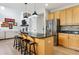 Contemporary kitchen design boasts an eat-in island with seating, stainless steel appliances, and granite countertops at 10029 Winterthur Ct, Highlands Ranch, CO 80129