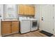 Functional laundry room with hardwood floors includes a utility sink, cabinets, and a washer and dryer at 10029 Winterthur Ct, Highlands Ranch, CO 80129