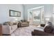 Comfortable living room with large windows, plush seating, and a stylish rug at 10029 Winterthur Ct, Highlands Ranch, CO 80129