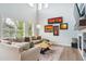The open-concept living room features a large window, hardwood floors, a decorative fireplace, and modern decor at 10029 Winterthur Ct, Highlands Ranch, CO 80129