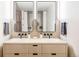 Bathroom featuring dual sinks, modern fixtures, and decorative mirrors at 2100 16Th St # 405, Denver, CO 80202