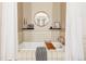 Bathroom with white tiled tub and walls featuring decorative wall art at 2100 16Th St # 405, Denver, CO 80202