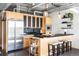 Eat-in kitchen boasts stainless steel appliances, sleek black countertops and stylish wooden cabinetry at 2100 16Th St # 405, Denver, CO 80202