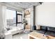 Well lit living room featuring modern furniture, a decorative concrete pillar and views of the city at 2100 16Th St # 405, Denver, CO 80202