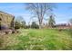 Large, grassy backyard with a covered patio and mature landscaping offers plenty of space to enjoy at 12323 W Connecticut Dr, Lakewood, CO 80228