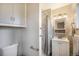 This bathroom includes a vanity, toilet, shower with marbled tiling, and natural light at 12323 W Connecticut Dr, Lakewood, CO 80228
