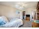 This bedroom includes a ceiling fan, closet, and window for natural light at 12323 W Connecticut Dr, Lakewood, CO 80228