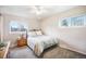 Tranquil bedroom with ample natural light, a ceiling fan, plush carpet, and two windows at 12323 W Connecticut Dr, Lakewood, CO 80228