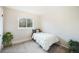 This bedroom includes carpet, a window for natural light, and warm neutral paint at 12323 W Connecticut Dr, Lakewood, CO 80228