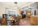 Eat-in kitchen area with natural wood cabinets, stainless steel appliances, and a sliding door to the outside at 12323 W Connecticut Dr, Lakewood, CO 80228