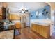 This bright kitchen offers stainless steel appliances, wooden cabinets, and a view to a painted blue wall at 12323 W Connecticut Dr, Lakewood, CO 80228