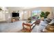 Inviting living room featuring a TV and entertainment center, a large window, and plush seating at 12323 W Connecticut Dr, Lakewood, CO 80228