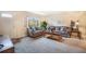 Cozy living room with neutral decor, large windows, plush seating, and ample natural light at 12323 W Connecticut Dr, Lakewood, CO 80228