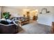 Comfortable living room featuring a neutral color scheme, a large sofa, and an open layout at 12323 W Connecticut Dr, Lakewood, CO 80228