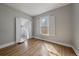 Sunlit bedroom with hardwood floors and a closet with bi-fold doors at 3420 Julian St, Denver, CO 80211