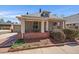 Charming home featuring a cozy front porch with inviting curb appeal and mature landscaping at 3420 Julian St, Denver, CO 80211