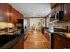 Open kitchen featuring stainless steel appliances, dark cabinets and hardwood floors at 3420 Julian St, Denver, CO 80211