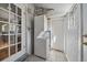 Functional laundry room features modern washer and dryer and tile flooring at 3420 Julian St, Denver, CO 80211