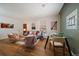 Open-concept living and dining room area featuring light wood floors and neutral paint at 3420 Julian St, Denver, CO 80211