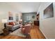 Inviting living room featuring hardwood floors and neutral paint, creating a cozy and comfortable space at 3420 Julian St, Denver, CO 80211