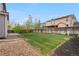 Large backyard with grass and partial rock landscaping at 10158 Granby St, Commerce City, CO 80022