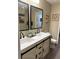 Modern bathroom featuring double sinks, barn-door vanity and stylish fixtures at 10158 Granby St, Commerce City, CO 80022