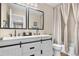 Updated bathroom featuring a dual sink vanity, modern fixtures and updated shower at 10158 Granby St, Commerce City, CO 80022