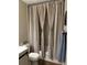 Bathroom showing a shower with tiled walls and neutral shower curtain at 10158 Granby St, Commerce City, CO 80022