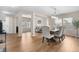 Open dining area with hardwood floors, contemporary chandelier, and adjacent living spaces at 10158 Granby St, Commerce City, CO 80022
