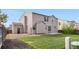 Back exterior of home with patio, grass, and rock landscaping at 10158 Granby St, Commerce City, CO 80022