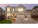 Charming two-story home featuring a three car garage, complemented by decorative stone and manicured lawn at 10158 Granby St, Commerce City, CO 80022