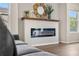 Modern fireplace in living room, featuring sleek design and wooden mantle, flanked by decorative accents at 10158 Granby St, Commerce City, CO 80022