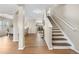 Bright foyer with wood floors, white trim, and a staircase leading to the second floor at 10158 Granby St, Commerce City, CO 80022
