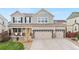 Inviting two-story home with a covered porch and a three car garage featuring stone accents at 10158 Granby St, Commerce City, CO 80022
