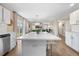 Bright, open kitchen featuring a large island, white cabinets and stainless steel appliances that opens to the living area at 10158 Granby St, Commerce City, CO 80022