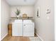 Functional laundry room with washer, dryer, shelving, and stylish decor at 10158 Granby St, Commerce City, CO 80022