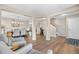 Open concept living space featuring wood floors, neutral tones, and access to the dining and staircase at 10158 Granby St, Commerce City, CO 80022