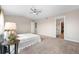 Spacious main bedroom featuring a ceiling fan, carpet floors, and an ensuite bathroom at 10158 Granby St, Commerce City, CO 80022