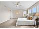 Spacious main bedroom with vaulted ceiling, large windows, and neutral decor at 10158 Granby St, Commerce City, CO 80022