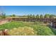 Well-maintained backyard features privacy fence, lawn, and garden at 10521 Taylor Ave, Firestone, CO 80504