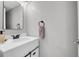 Modern half bathroom featuring a white vanity with stylish black hardware at 10521 Taylor Ave, Firestone, CO 80504