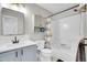 Bathroom featuring modern vanity with sink and tub with nautical themed curtain at 10521 Taylor Ave, Firestone, CO 80504
