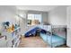 bedroom featuring wood floors, bunk bed with slide, and natural light at 10521 Taylor Ave, Firestone, CO 80504