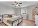 Cozy bedroom features wood floors, natural light, and neutral decor at 10521 Taylor Ave, Firestone, CO 80504