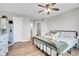 Neutral bedroom featuring wood floors, neutral decor, and natural light at 10521 Taylor Ave, Firestone, CO 80504